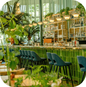 A bar with green tile walls and blue chairs
AI-generated content may be incorrect.